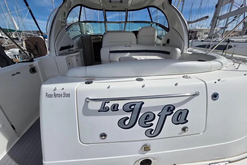 Slide: The Image of 2007 Sea Ray 40 Sundancer yacht "La Jefa" with spacious seating and "Please Remove Shoes" sign. - 20
