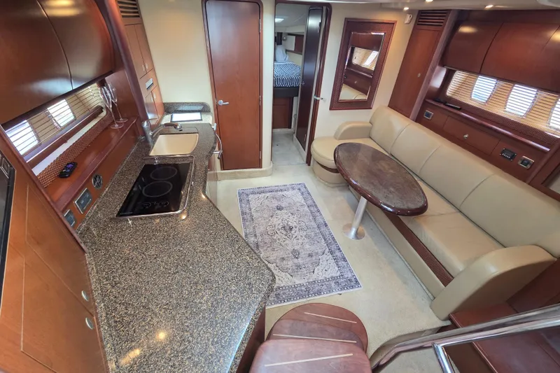 Slide: The Image of Luxurious interior of 2007 Sea Ray 40 Sundancer yacht with kitchen and seating area. - 9