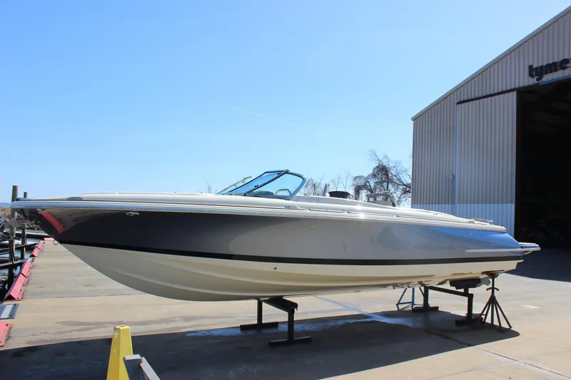 The Image of 2024 Chris-Craft Launch 27 boat on display outside a warehouse. - 0