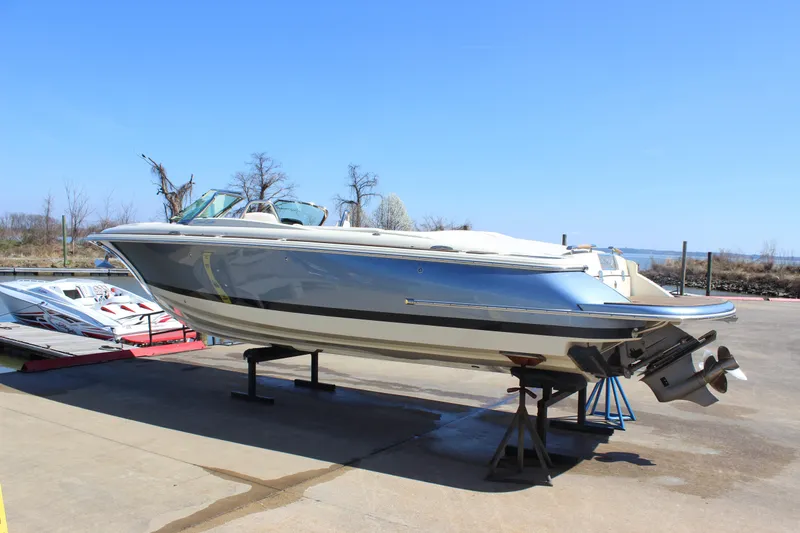 Slide: The Image of 2024 Chris-Craft Launch 27 boat on display outdoors, side view. - 1