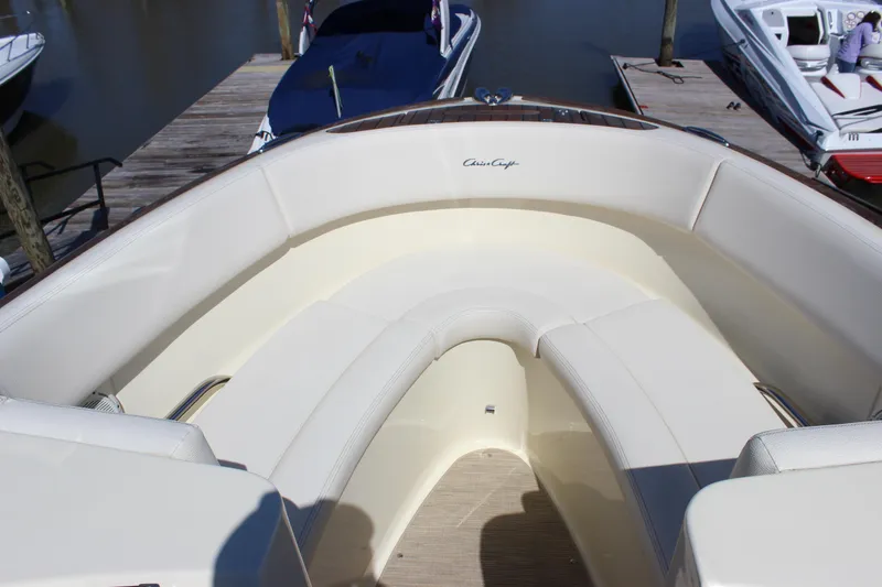 Slide: The Image of 2024 Chris-Craft Launch 27 boat interior with elegant seating at a dock. - 11