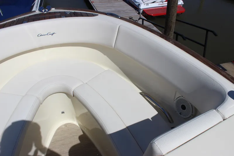 Slide: The Image of 2024 Chris-Craft Launch 27 boat interior with white seating and wood accents. - 13