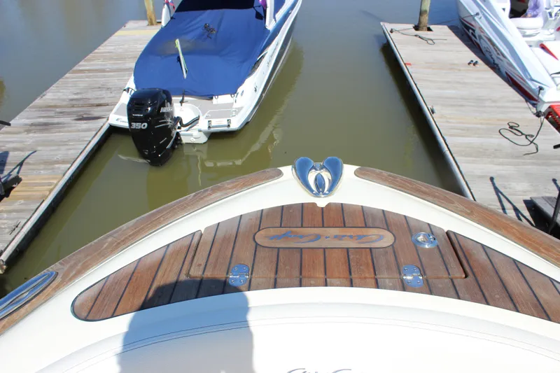 Slide: The Image of 2024 Chris-Craft Launch 27 docked, showcasing elegant wooden deck and sleek design. - 14