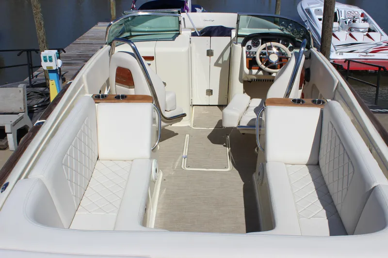Slide: The Image of 2024 Chris-Craft Launch 27 boat interior with luxurious white seating and elegant dashboard. - 17