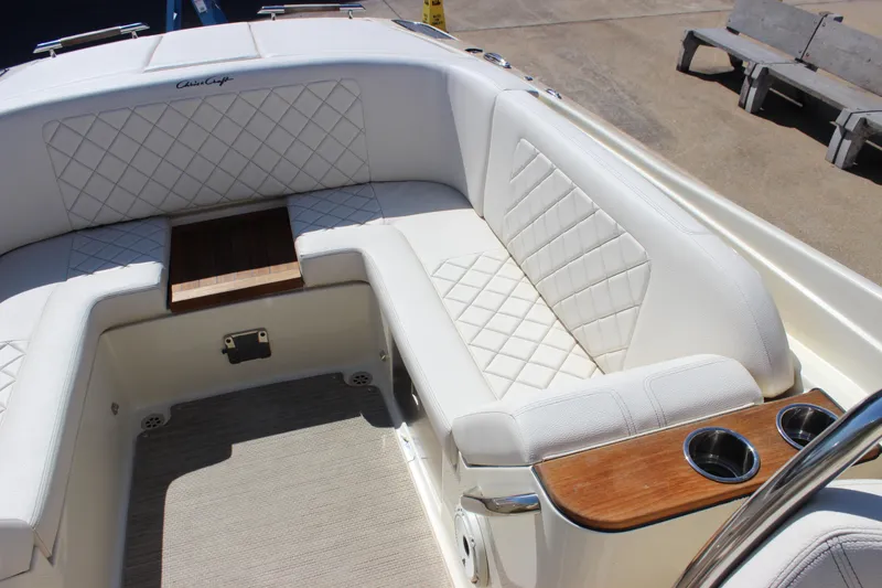 Slide: The Image of Luxurious interior of 2024 Chris-Craft Launch 27 boat with white quilted seating. - 18