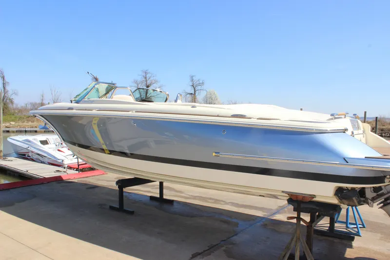 Slide: The Image of 2024 Chris-Craft Launch 27 boat on a stand, dockside view. - 2