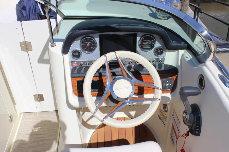 Slide: The Image of 2024 Chris-Craft Launch 27 dashboard with steering wheel and control panel. - 22