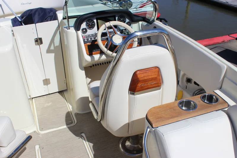 Slide: The Image of 2024 Chris-Craft Launch 27 boat interior with steering wheel and luxurious seating. - 23