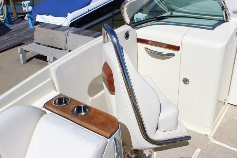 Slide: The Image of 2024 Chris-Craft Launch 27 boat interior with white seating and cup holders. - 24
