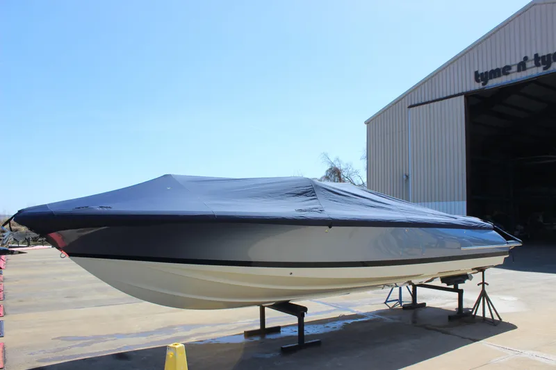Slide: The Image of 2024 Chris-Craft Launch 27 boat covered, positioned outside a large storage facility. - 26