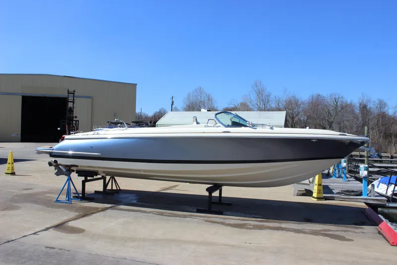 Slide: The Image of 2024 Chris-Craft Launch 27 boat on display at a marina under clear blue sky. - 4