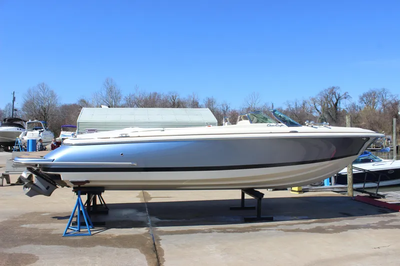 Slide: The Image of 2024 Chris-Craft Launch 27 boat on display, side view, outdoors on a sunny day. - 7