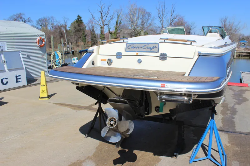 Slide: The Image of 2024 Chris-Craft Launch 27 boat on dry dock, showcasing rear view and propeller. - 8
