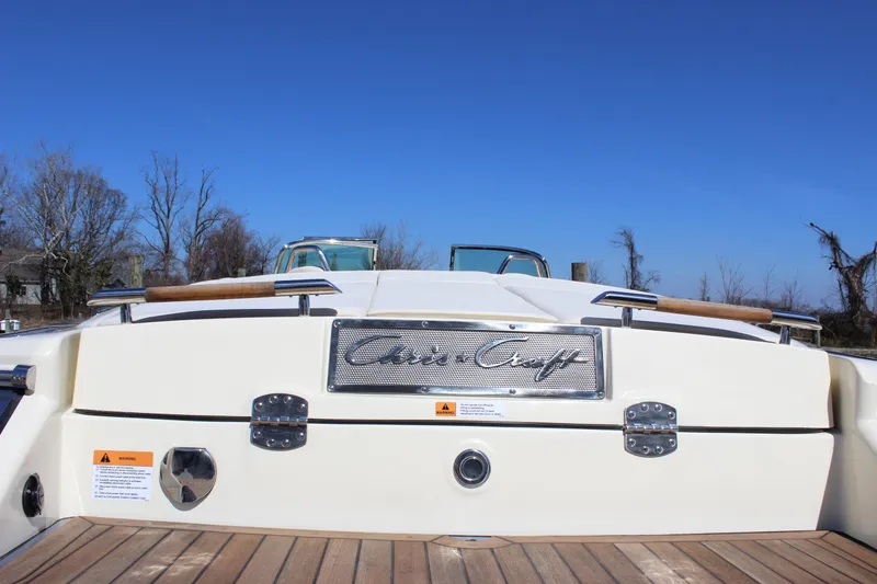 Slide: The Image of 2024 Chris-Craft Launch 27 boat, rear view with teak deck and signature logo. - 9