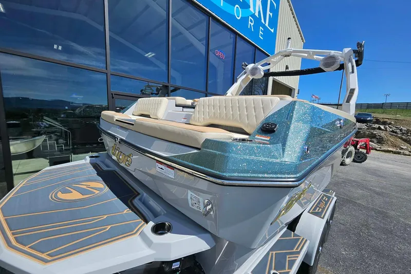 Slide: The Image of 2026 Tigé Z3 boat with sparkling blue finish, displayed outside a store. - 8