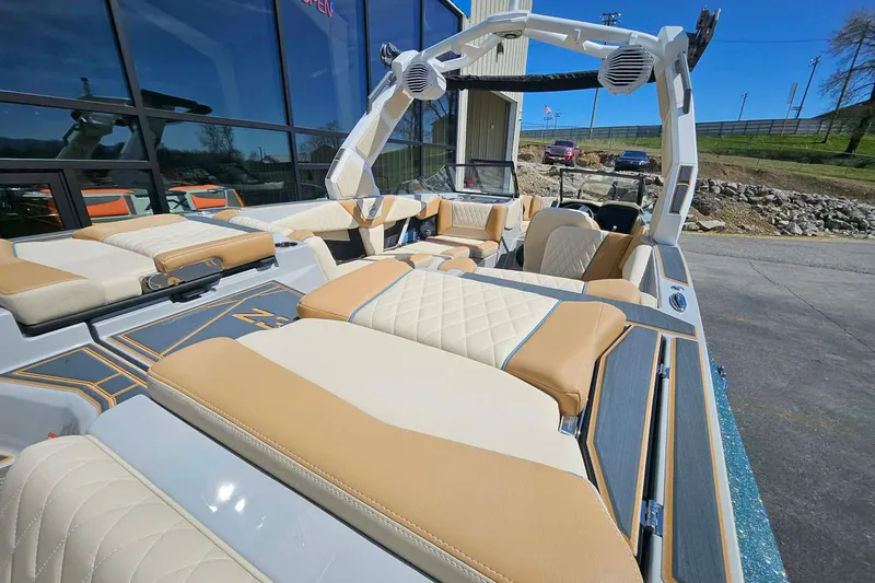 Slide: The Image of 2026 Tigé Z3 boat with luxurious tan and white seating, parked outdoors. - 9