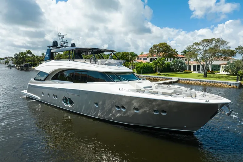 The Image of 2015 Monte Carlo Yachts MCY 86 luxury yacht cruising on a scenic waterway. - 0