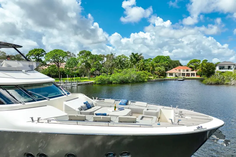 Slide: The Image of Luxurious 2015 Monte Carlo Yachts MCY 86 docked by scenic waterfront homes. - 11