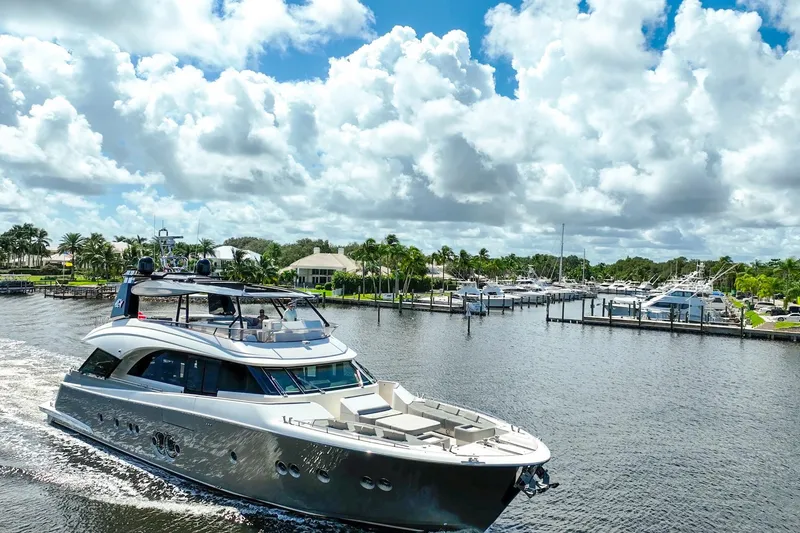 Slide: The Image of Luxurious 2015 Monte Carlo Yachts MCY 86 cruising in a scenic marina setting. - 22
