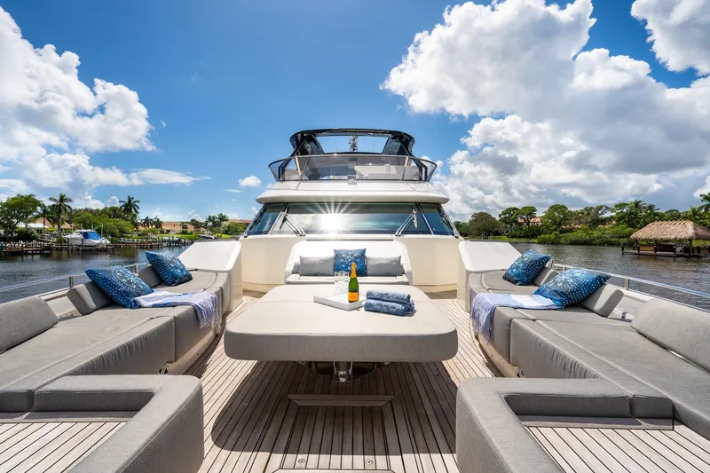 Slide: The Image of Luxurious 2015 Monte Carlo Yachts MCY 86 with elegant deck seating and scenic waterfront view. - 26