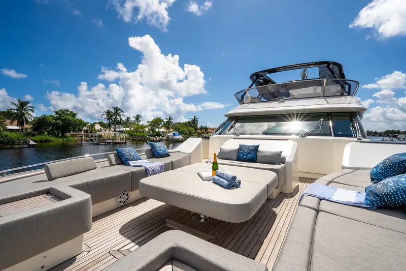 Slide: The Image of Luxurious 2015 Monte Carlo Yachts MCY 86 deck with elegant seating and scenic waterfront view. - 28