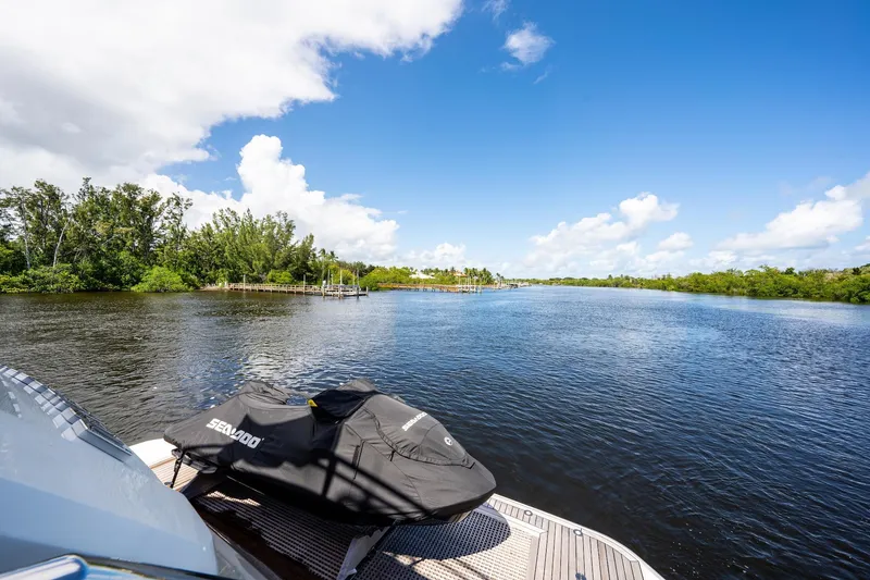 Slide: The Image of 2015 Monte Carlo Yachts MCY 86 on serene river with clear blue sky. - 29