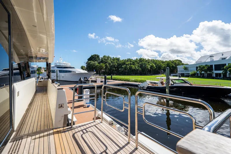 Slide: The Image of Luxurious 2015 Monte Carlo Yachts MCY 86 docked, showcasing elegant design and serene waterfront setting. - 30