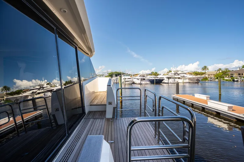 Slide: The Image of 2015 Monte Carlo Yachts MCY 86 docked, reflecting on calm marina waters. - 33