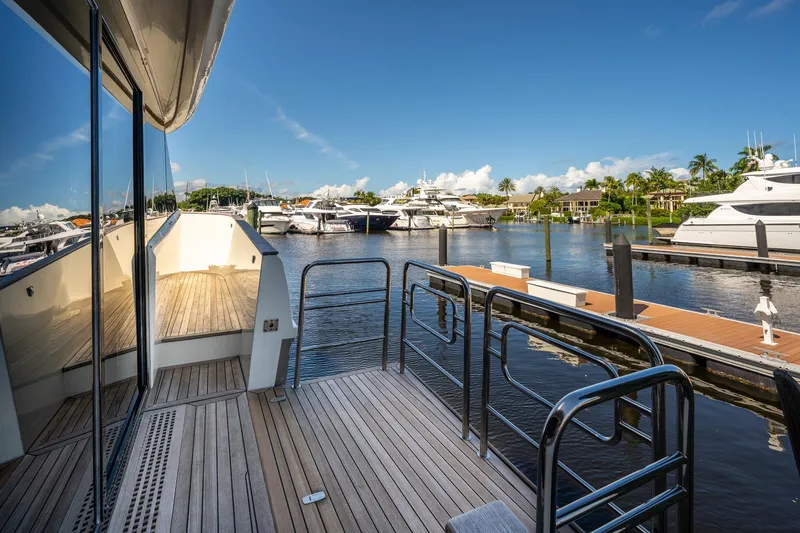 Slide: The Image of Luxurious 2015 Monte Carlo Yachts MCY 86 docked at a scenic marina. - 34