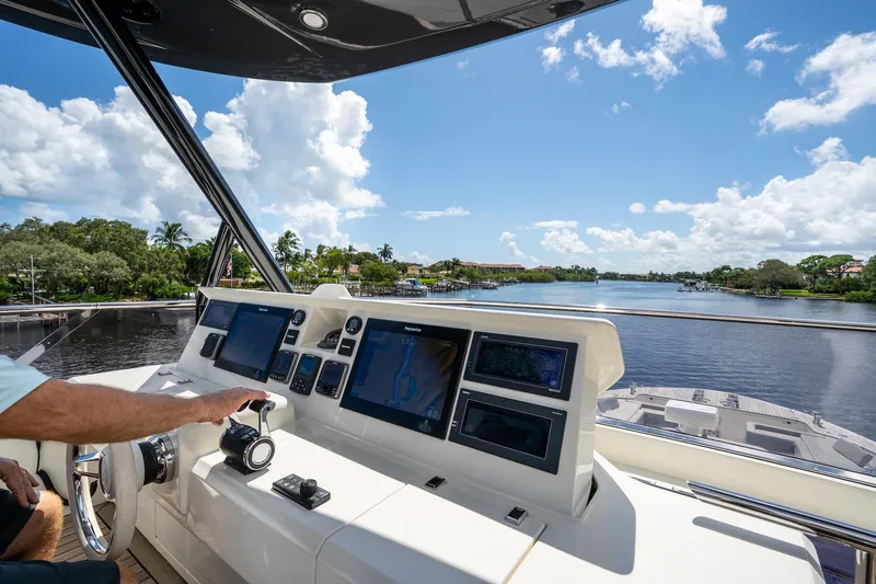 Slide: The Image of Cockpit view of 2015 Monte Carlo Yachts MCY 86 navigating a scenic waterway. - 35