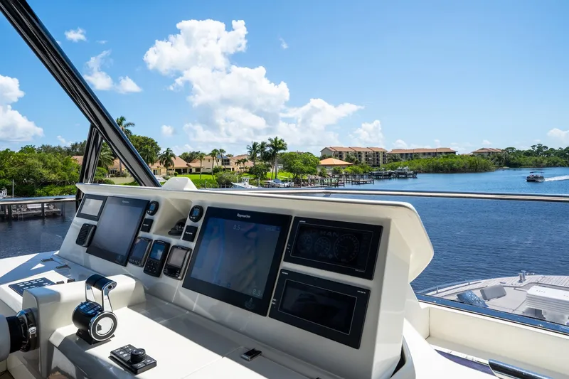 Slide: The Image of Cockpit view of 2015 Monte Carlo Yachts MCY 86, overlooking serene waterfront scenery. - 36