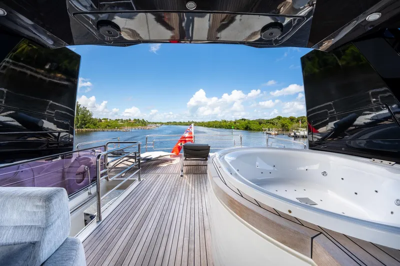 Slide: The Image of Luxurious 2015 Monte Carlo Yachts MCY 86 deck with jacuzzi and scenic waterway view. - 39