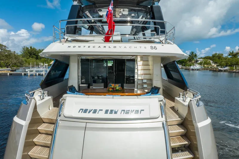 Slide: The Image of Luxury Monte Carlo Yachts MCY 86, 2015 model, docked with elegant design and spacious deck. - 4