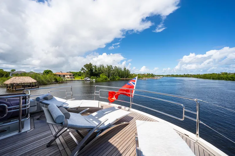 Slide: The Image of Luxurious Monte Carlo Yachts MCY 86 deck with sun loungers, scenic river view, 2015 model. - 41