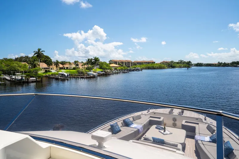 Slide: The Image of Luxurious 2015 Monte Carlo Yachts MCY 86 on serene waterfront with clear blue skies. - 44