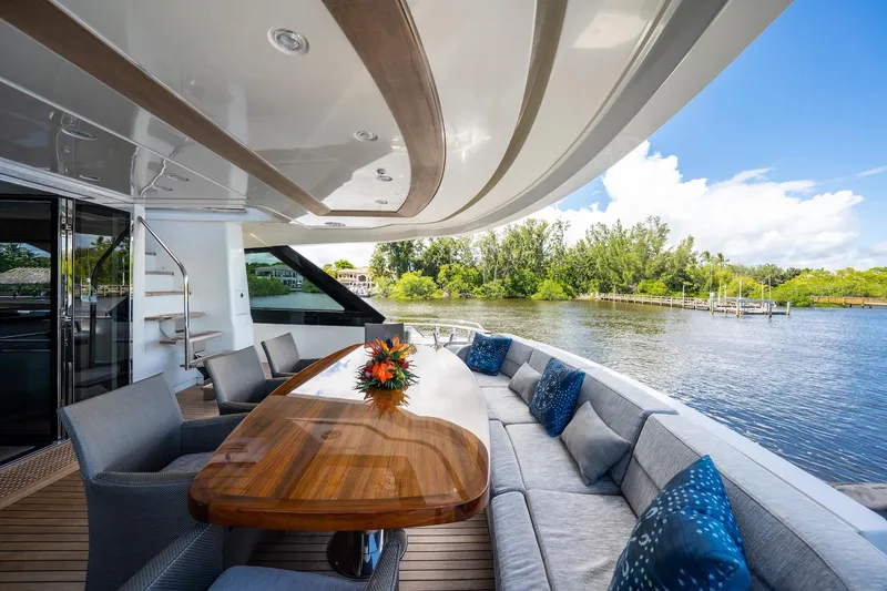 Slide: The Image of Luxurious 2015 Monte Carlo Yachts MCY 86 deck with elegant seating and scenic water view. - 56