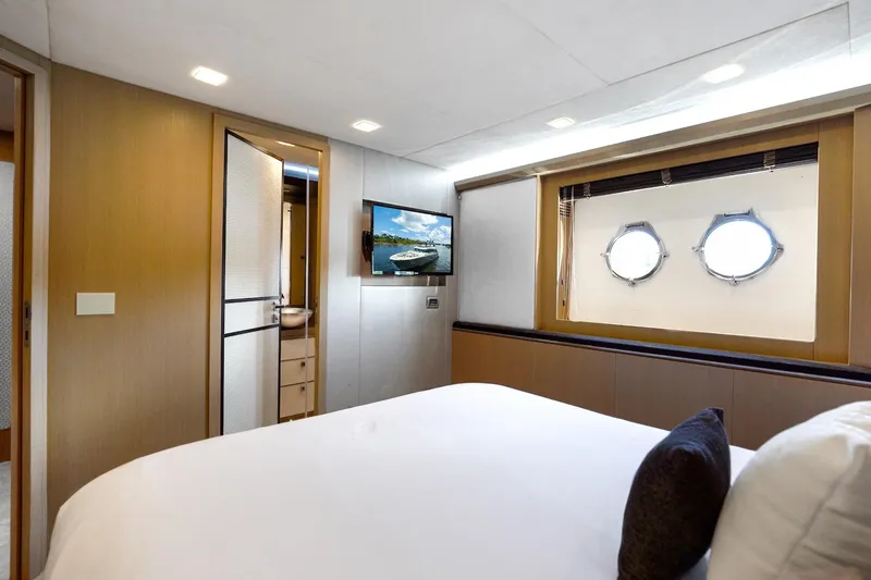 Slide: The Image of Luxurious bedroom interior of 2015 Monte Carlo Yachts MCY 86 with porthole windows. - 64