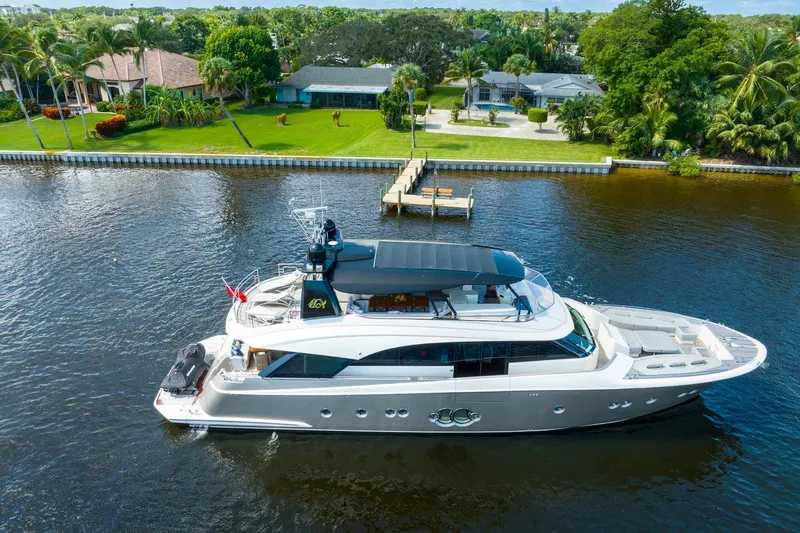 Slide: The Image of Luxurious 2015 Monte Carlo Yachts MCY 86 cruising on a serene waterfront. - 9