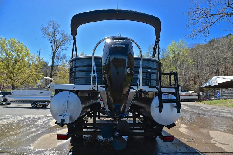 Slide: The Image of 2022 Bennington 22 L pontoon boat with outboard motor, parked outdoors. - 13