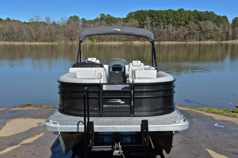 Slide: The Image of 2022 Bennington 22 L pontoon boat on a serene lake backdrop. - 17
