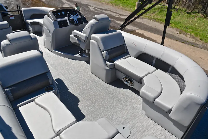 Slide: The Image of 2022 Bennington 22 L pontoon boat interior with luxurious seating and modern helm. - 23
