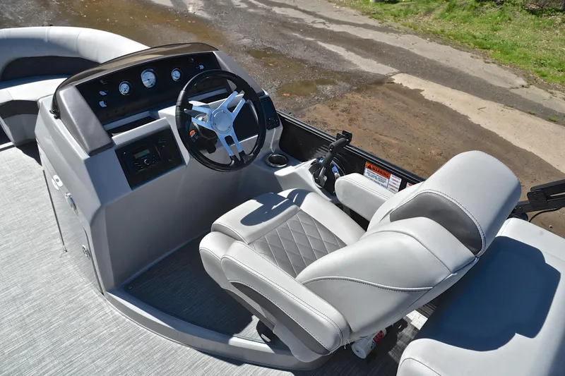 Slide: The Image of 2022 Bennington 22 L boat interior with steering wheel and captain's chair. - 24