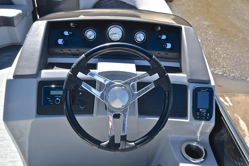 Slide: The Image of Steering console of a 2022 Bennington 22 L boat with gauges and controls. - 25