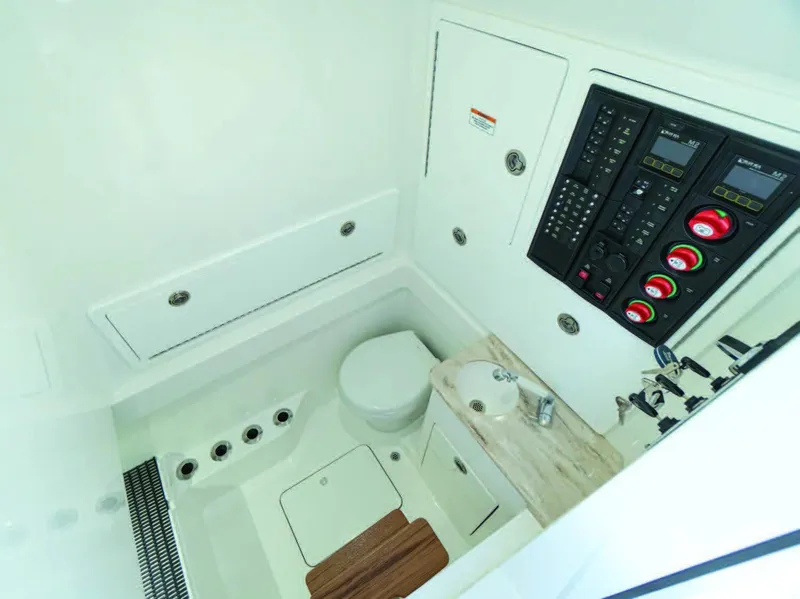Slide: The Image of 2026 Valhalla Boatworks V-37 interior with control panel and compact bathroom. - 26