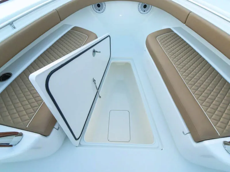 Slide: The Image of 2026 Valhalla Boatworks V-37 interior with open storage compartment and cushioned seating. - 36