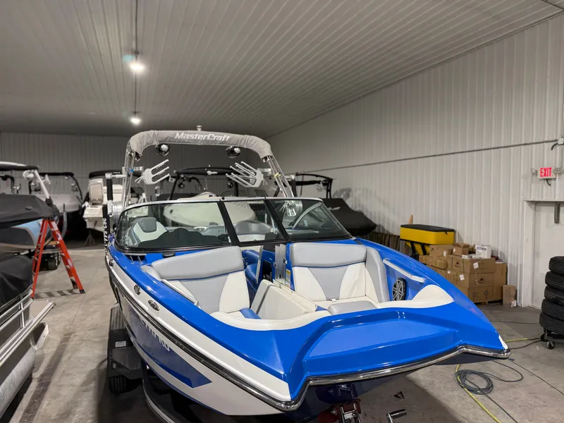 Slide: The Image of 2016 MasterCraft X20 boat in warehouse, blue and white design. - 3