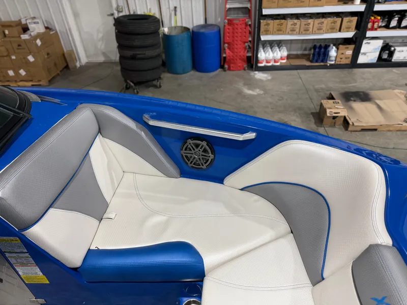 Slide: The Image of Interior of a 2016 MasterCraft X20 boat with blue and gray seating. - 32