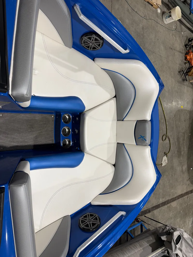 Slide: The Image of Interior of a 2016 MasterCraft X20 boat with blue and white seating. - 34