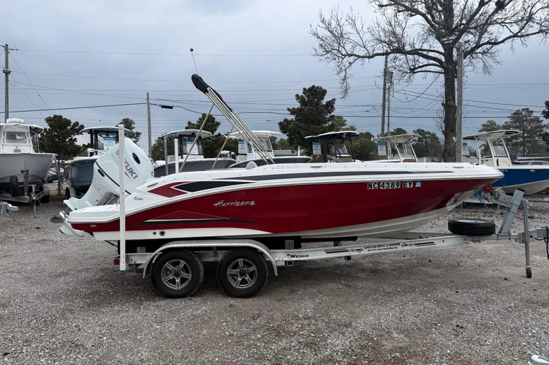 Slide: The Image of 2022 Hurricane SunDeck Sport 205 OB boat on trailer, red and white design. - 10