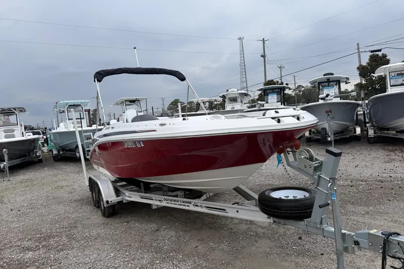 Slide: The Image of 2022 Hurricane SunDeck Sport 205 OB boat on trailer in a dealership lot. - 12